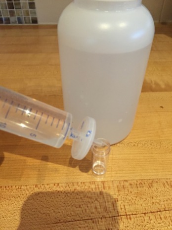 With a filer placed on the end of the syringe, water is put into the auto analyzer cup.